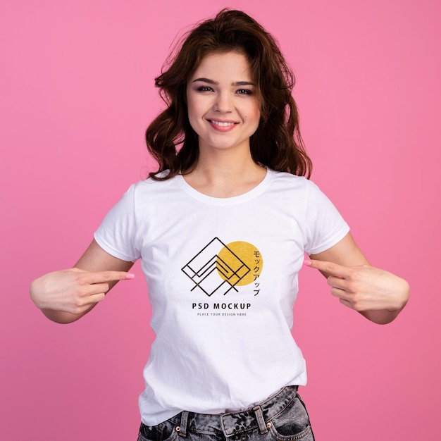 Person with excited expression pointing to tshirt mockup