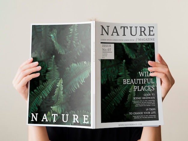Womans hand holding a nature magazine mock up