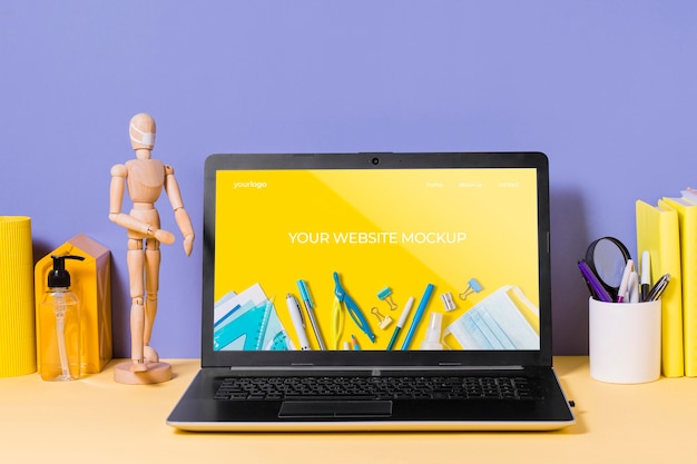 PSD wooden mannequin and laptop with mock-up