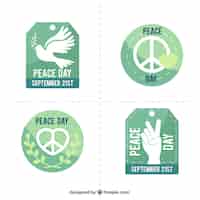 Vector gratuito selección de insignias en tonos verdes para el día internacional de la paz