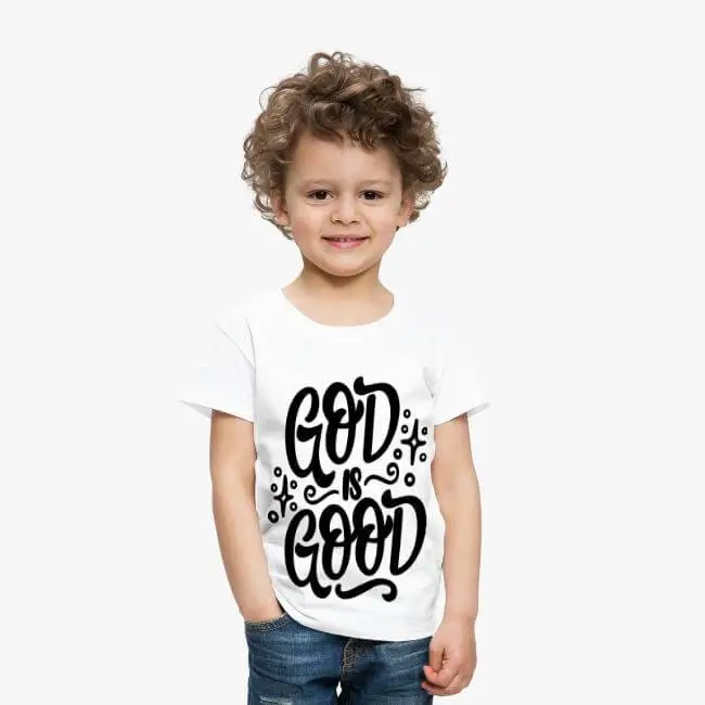 Child in a Jesus Shirt with the message 'God is Good' radiates positivity and faith.