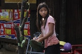 A girl searches for salvageable items after flash floods in Macasandig town, in southern Philippines.