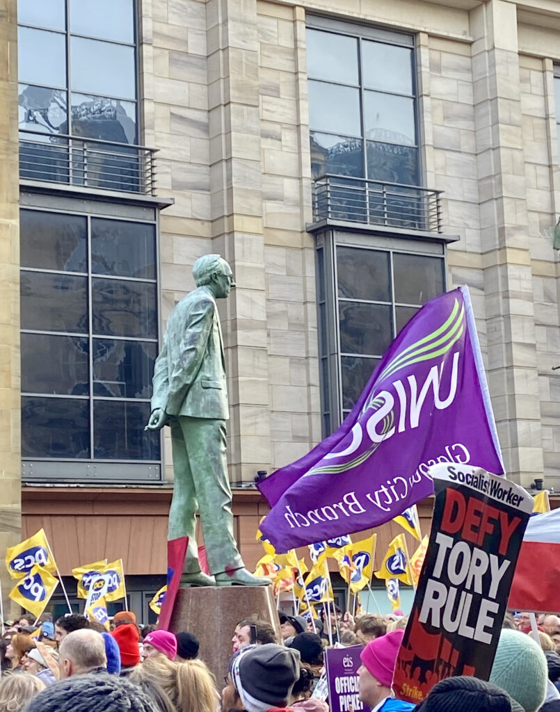 Photograph of statue of Donald Dewar surrounded by banners during Right to Strike rally.  Buchanan Street, Glasgow. 