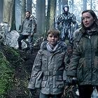 Molly Parker, Brian Steele, Toby Stephens, and Maxwell Jenkins in Lost in Space (2018)