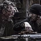 John Hurt and Chris Evans in Snowpiercer (2013)