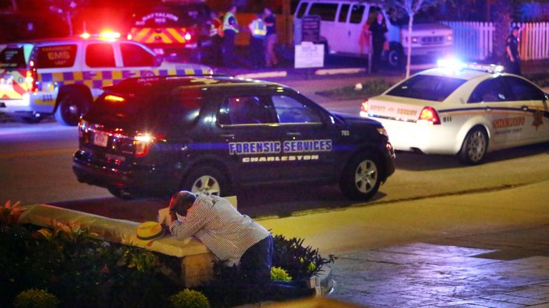 A man kneels across the street from the historic Emanuel African Methodist Episcopal Church in Charleston, South Carolina, <a href="http://www.cnn.com/2015/06/18/us/gallery/charleston-south-carolina-church-shooting/index.html" target="_blank"