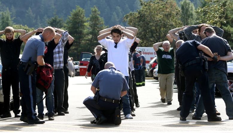 Police search students outside Umpqua Community College after <a href="http://www.cnn.com/2015/10/01/us/gallery/oregon-shooting-umpqua-community-college/index.html" target="_blank"
