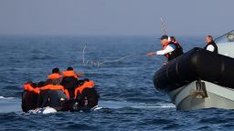 Border Force officers assist 20 Syrian migrants aboard HMC Hunter on August 10, 2020, after they were stopped as they crossed The Channel in an inflatable dinghy headed in the direction of England. (Photo by Gareth Fuller/PA Images via Getty Images)