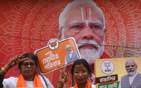 Supporters of the Bharatiya Janata Party (BJP) are holding a cutout of a portrait of India&#039;s Prime Minister Narendra Modi ahead of the roadshow in Kolkata, India, on May 28, 2024, ahead of the seventh and final phase of voting in the country&#039;s general election. (Photo by Debajyoti Chakraborty/NurPhoto) (Photo by Debajyoti Chakraborty / NurPhoto / NurPhoto via AFP)
