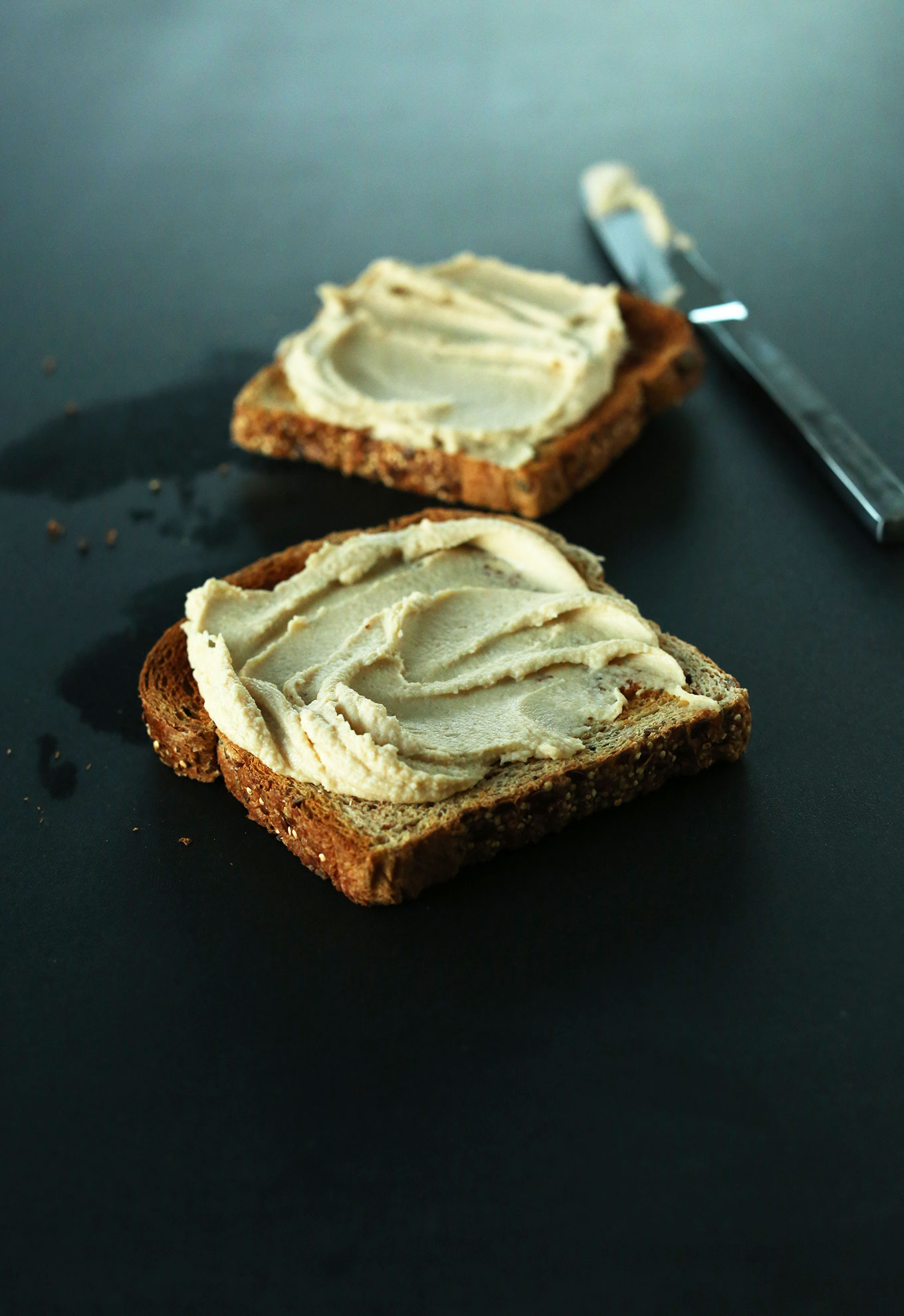 Two slices of toast with hummus for a protein-rich vegan snack