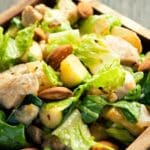 closeup of a wood bowl filled with Chicken and zucchini hot salad