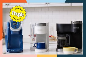 Three Keurig coffee makers on a counter with a colorful border.