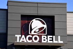 An exterior view shows a sign at a Taco Bell restaurant