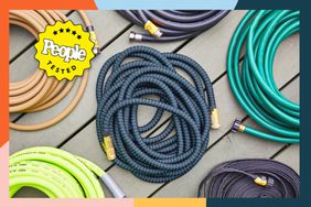 Several of the best garden hoses wrapped up next to each other on a deck with a colorful border.