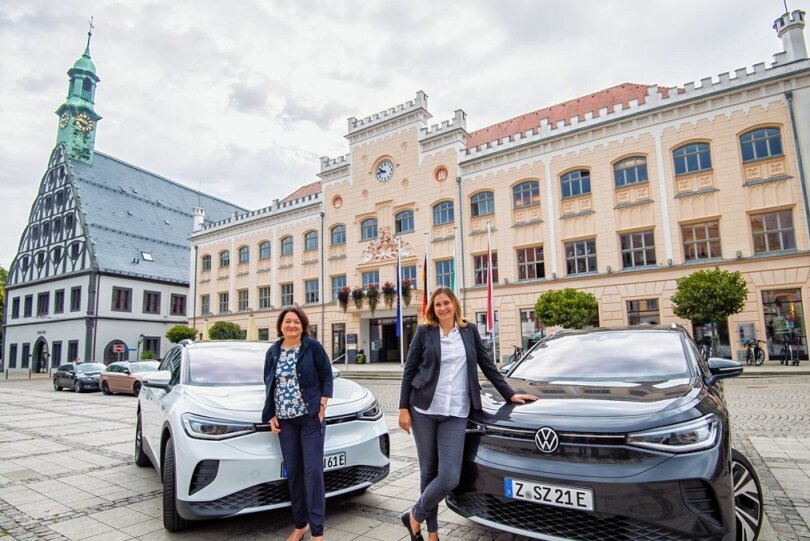 Karen Kutzner (links) und Constance Arndt fahren beide einen ID.4 von VW. Die elektrisch angetriebenen SUVs durften für das Foto ausnahmsweise mittig auf dem Hauptmarkt parken. 