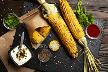 Grilled corn on the cob on kitchen table flat lay healthy food background