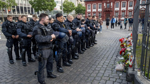 German police officers commemorate a colleague in Mannheim Germany, after learning that a police officer, who was stabbed two days ago there, has died on June 2, 2024.