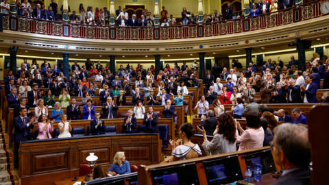 Some Spanish lawmakers applaud after a bill granting amnesty to those involved in Catalonia's failed independence bid in 2017 was approved in parliament in Madrid on May 30, 2024.