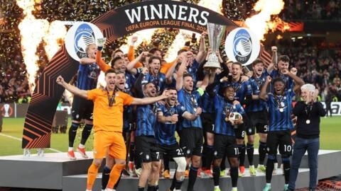 لاعبو أتالانتا يحتفلون بالكأس على منصة التتويج بعد فوزهم في مباراة كرة القدم النهائية للدوري الأوروبي UEFA على باير ليفركوزن في ملعب دبلن أرينا بالعاصمة الإيرلندية، في 22 أيار/مايو 2024. 