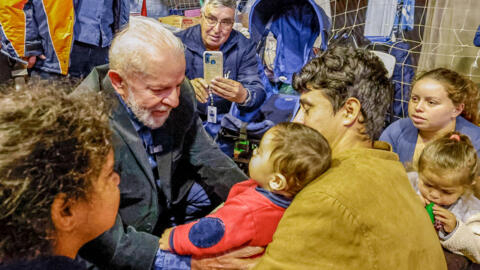 Brazilian President Luiz Inacio Lula da Silva (L) greets flood victims at a shelter in São Leopoldo, Rio Grande do Sul State, May 15, 2024.