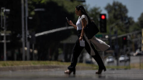 A person crosses an empty street as temperatures are expected to soar above 100 degrees Fahrenheit (37.8 degrees Celsius) during the summer's first heat, in Sacramento, California, US, June 4, 2024.