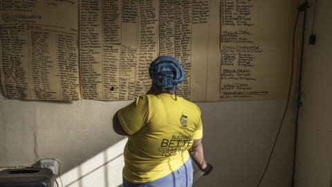 An ANC supporter looks at a campaign meeting roll call in Philipstown, South Africa on May 22, 2024.
