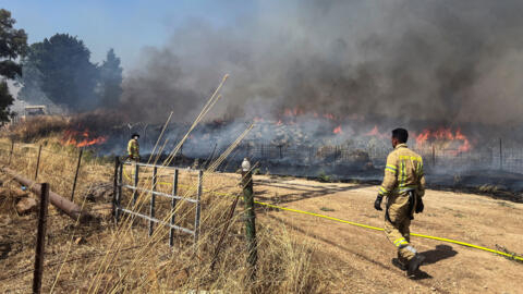 Israeli firefighters work following rocket attacks from Lebanon, amid ongoing cross-border hostilities between Hezbollah and Israeli forces, near the border on its Israeli side, June 13, 2024.