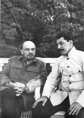Photo of Lenin and Stalin seated outdoors.