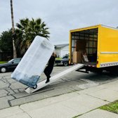 Safely transporting a wrapped couch to its new home! Our movers ensure every item arrives securely. #MovingDay