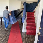 This is a picture of our movers moving a couch. We use carpets to protect the floors.