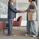 Smiling female executive manager is making successful deal with partner shaking hand at work  - PhotoDune Item for Sale