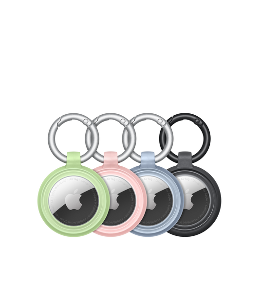 Cuatro fundas Lumen Series de OtterBox en verde, rosa, azul y negro con los AirTag con logotipos de Apple acoplados de forma segura en el centro de cada una.