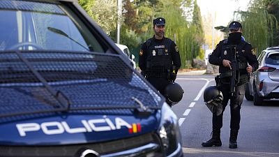 Police officers stand guard as they cordon off the area in Madrid, 30 November 2022