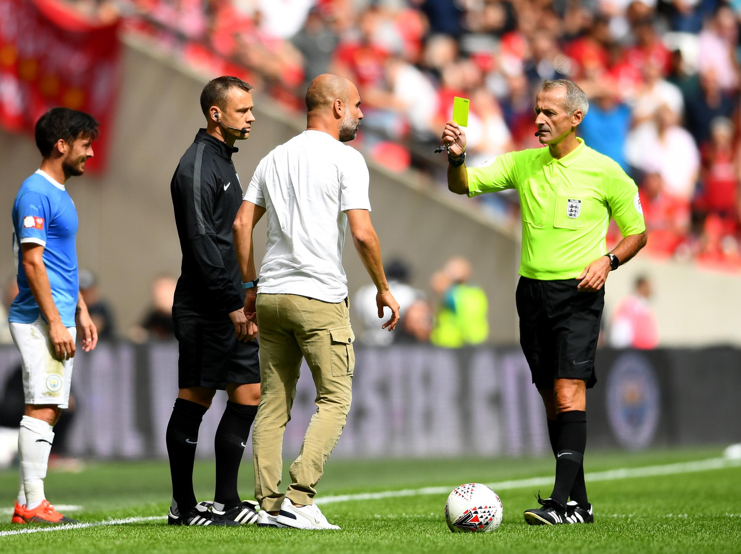 Guardiola is shown a yellow card during the Community Shield
