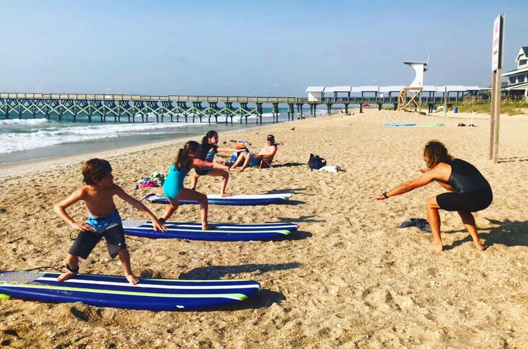 Sean Griffin instructs young surfers on Wrightsville Beach, N.C., which has some of the best breaks for beginners in the United States. This image is from the May article “6 Beaches for Budding Swimmers, Surfers and Castle Builders,” which, like all the articles we list below, students can read for free.